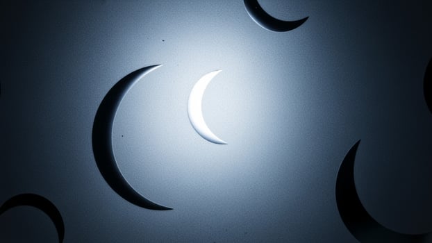 The moon is seen in the dark sky with a crescent photo