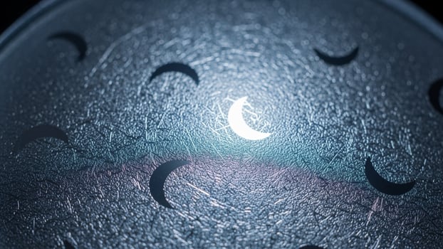 A moon and stars are shown in a glass ball photo