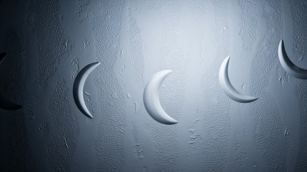A group of crescent moons are shown on a wall photo