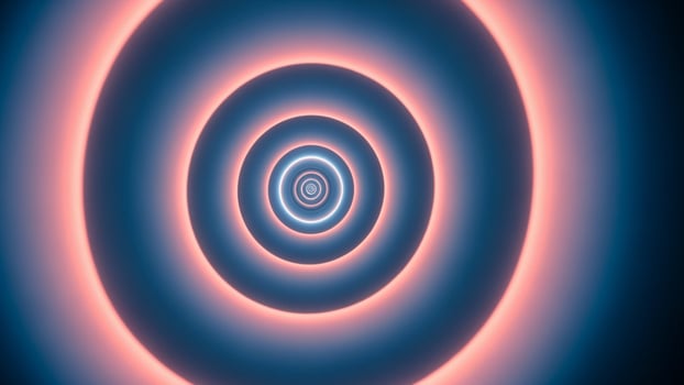 A blue and pink spiral in the center of a dark background photo