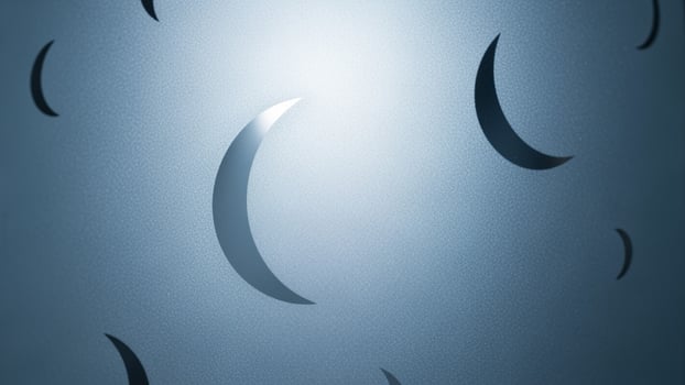 A blue background with a few crescent shaped shapes photo