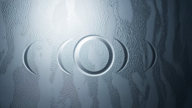 A close up of a frosted glass door with a circle on it photo