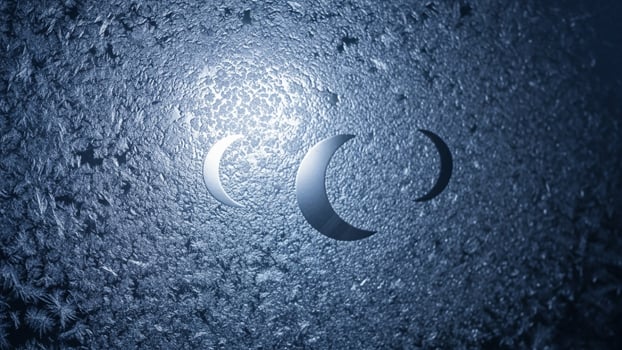 A blue background with a crescent moon on it photo