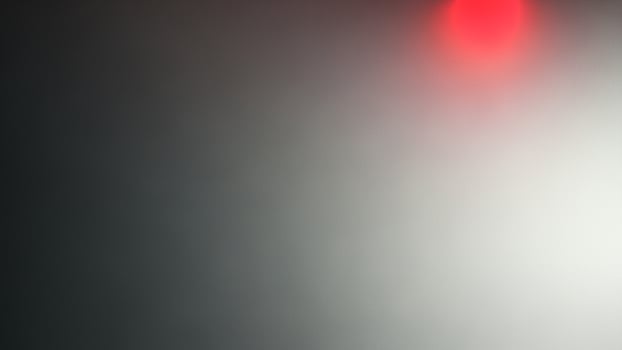 A red traffic light is on a dark background photo