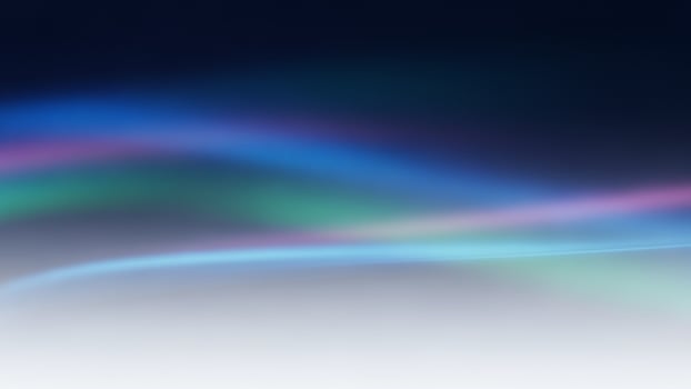A blue and green light is shining on a dark background photo