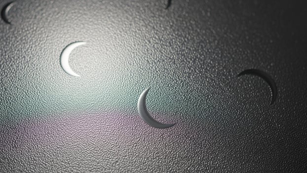 A photo of a moon with a crescent on it