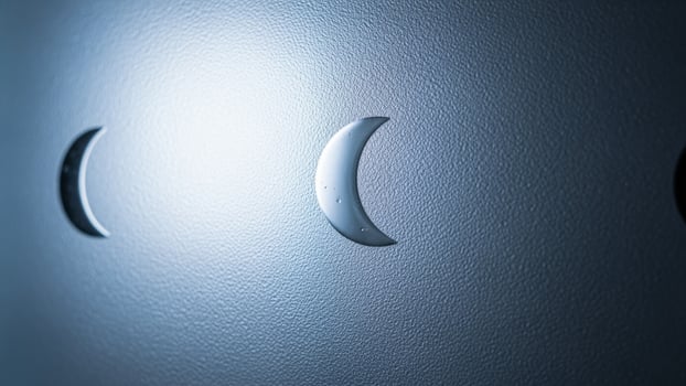 A close up of three crescent moons on a wall photo