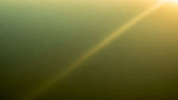 A blurry image of a plane flying over a green field photo