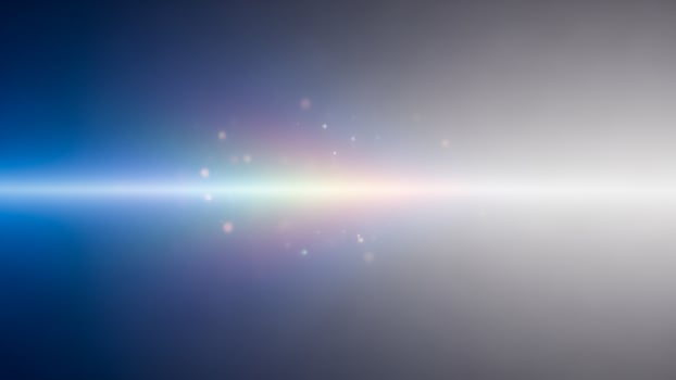 A rainbow light is shining through a dark background photo