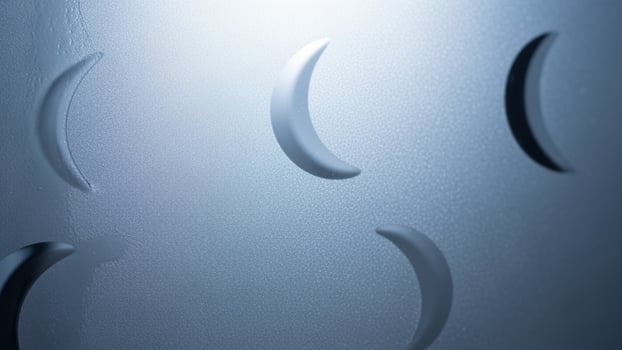 A close up of a metal surface with a number of crescent shapes photo