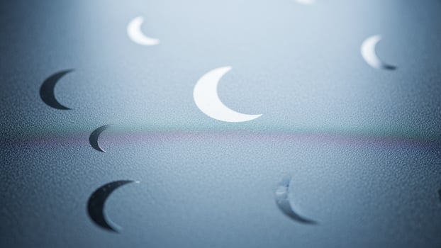 A crescent moon is shown in the sky photo