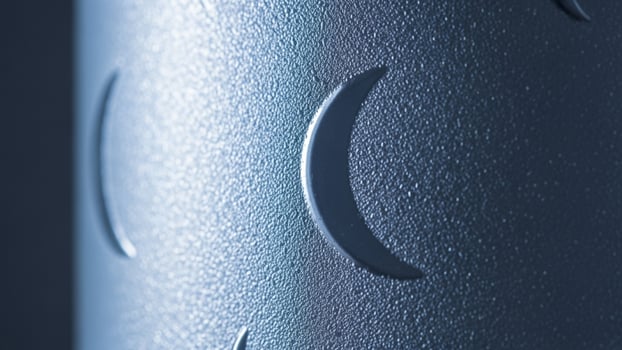 A close up of a metal object with a crescent moon photo
