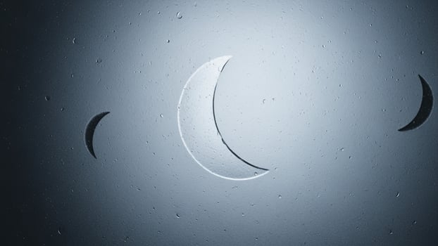The moon is seen in the sky with a crescent photo