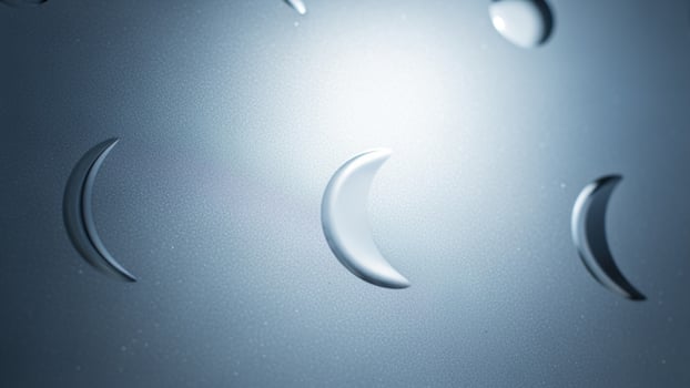 A close up of a metal surface with a moon and a crescent photo