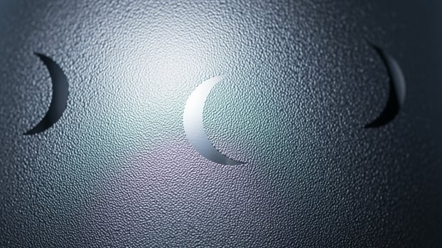 A close up of three crescents on a metal surface photo