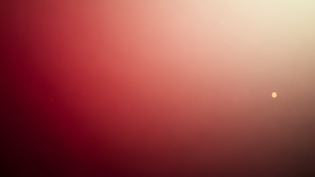 A red and yellow light is shining in the dark photo
