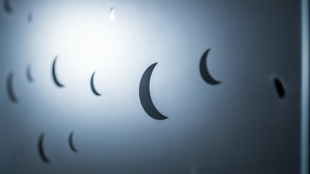 A close up of a metal wall with many holes photo