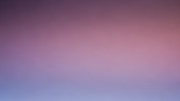 A purple and pink blurred background with a blue sky photo