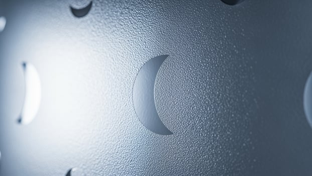 A close up of a metal wall with holes photo