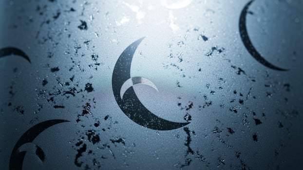 A close up of a crescent moon on a glass surface photo