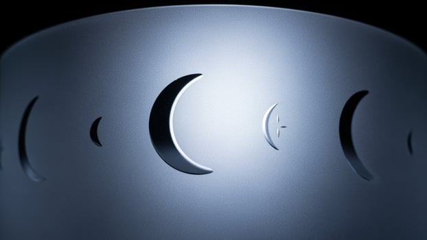 A close up of a metal object with four crescent moon shapes photo
