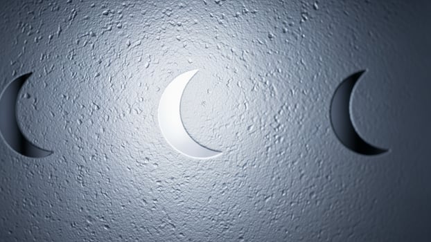 Three crescent moon lights are shown on a wall photo