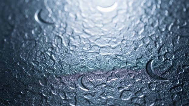 A close up of a wet glass surface with rain drops photo