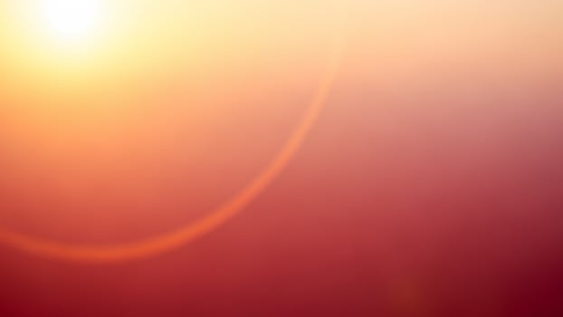 A blurry image of the sun rising over a field photo