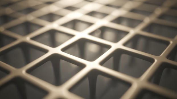 A close up of a metal grid with many squares photo