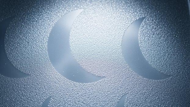 A close up of a metal plate with a moon on it photo
