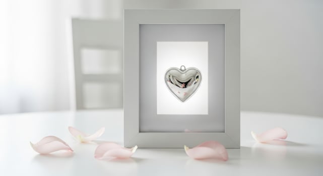 Silver heart ornament in a white frame isolated on white background photo