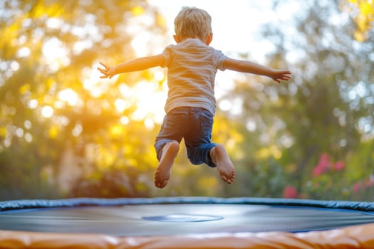 A young boy jumping on an inflatable trampoline photo