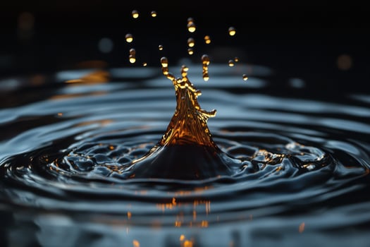 A drop of water is falling into the water photo
