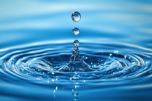 Water droplets falling into the water photo