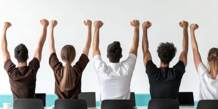 Multi cultural team concept, Team celebrating success with raised arms in office setting photo