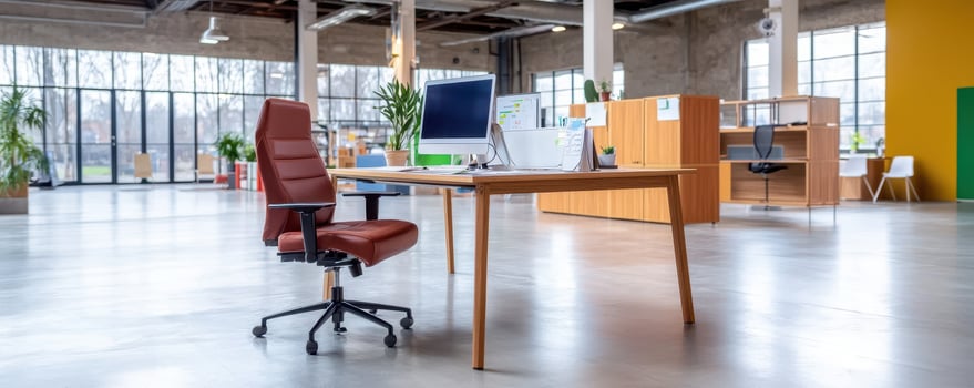 Modern office workspace with leather chair and computer on wooden desk in bright room photo