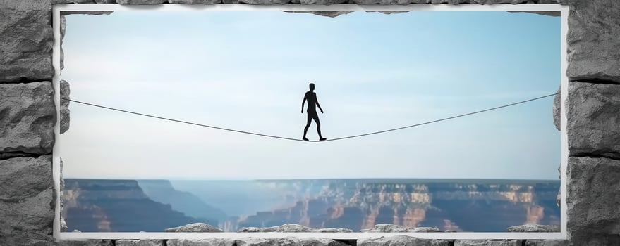 Goal of life and perseverance achievement concept, person walking on tightrope over canyon photo