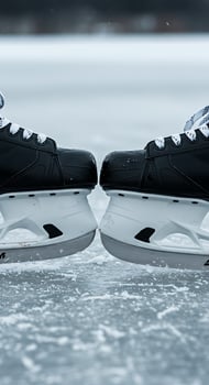 Two pairs of ice skates on a frozen lake photo