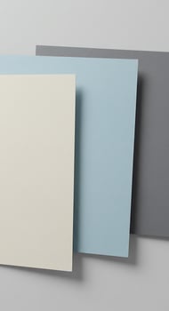 Three different colored paper sheets on a table photo