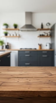 Wooden table top in kitchen with black appliances photo