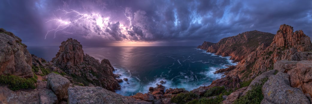Dramatic Coastal Landscape with Lightning Storm Over Ocean and Rugged Cliffs at Dusk Captured in Panoramic View photo