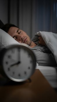 Peaceful Slumber Before Dawn with Blurred Alarm Clock in Foreground photo