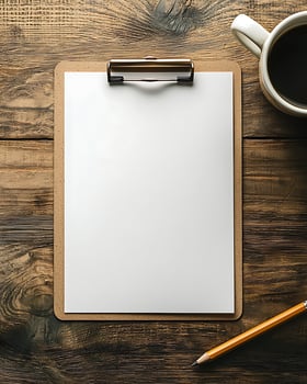 Blank Clipboard and Pencil on Wooden Desk with Coffee Mug photo