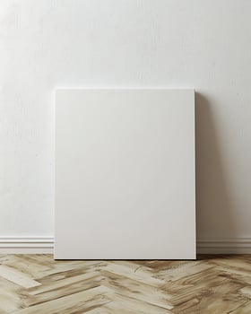 Blank White Canvas Leaning Against A Textured Wall On Hardwood Floor photo