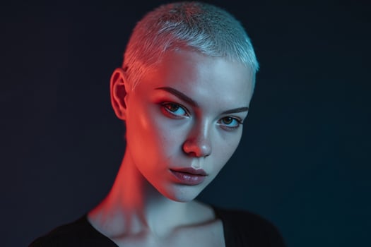 Under moody neon lights, an enigmatic young Caucasian woman with ethereal white hair invokes Future Day and Glamourfest vibes photo