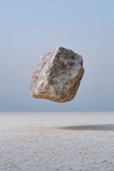 Floating mystic rock defies gravity, evoking stillness and Zen contemplation, ideal for Earth Day or Stone Skipping Fest photo