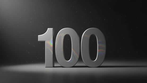 The word 100 is shown in a dark room photo