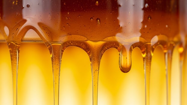 A close up of a glass of liquid with syrup photo