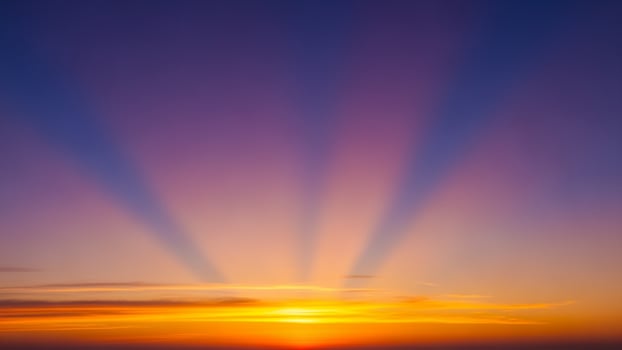 Sunset over the ocean with rays of light photo
