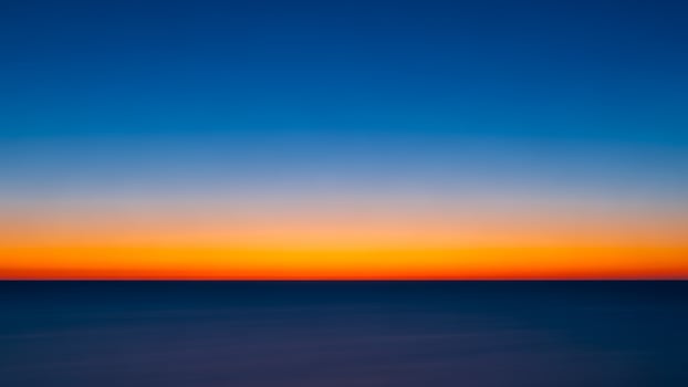 A long exposure of the sunset over the ocean photo
